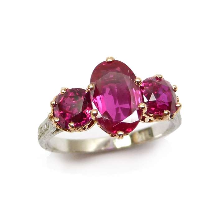 Three stone Burma ruby ring, centred by an oval ruby of 2.16ct,